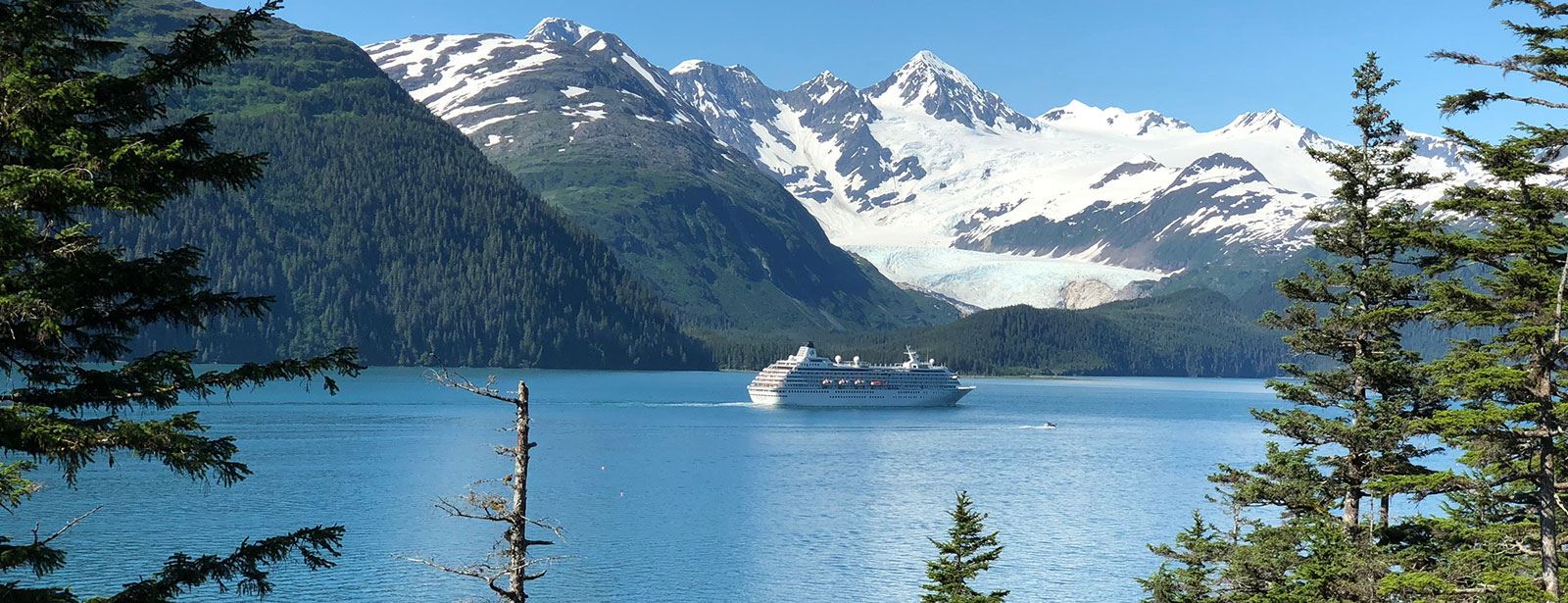 Alaska cruise ship sailing past glacier scenery